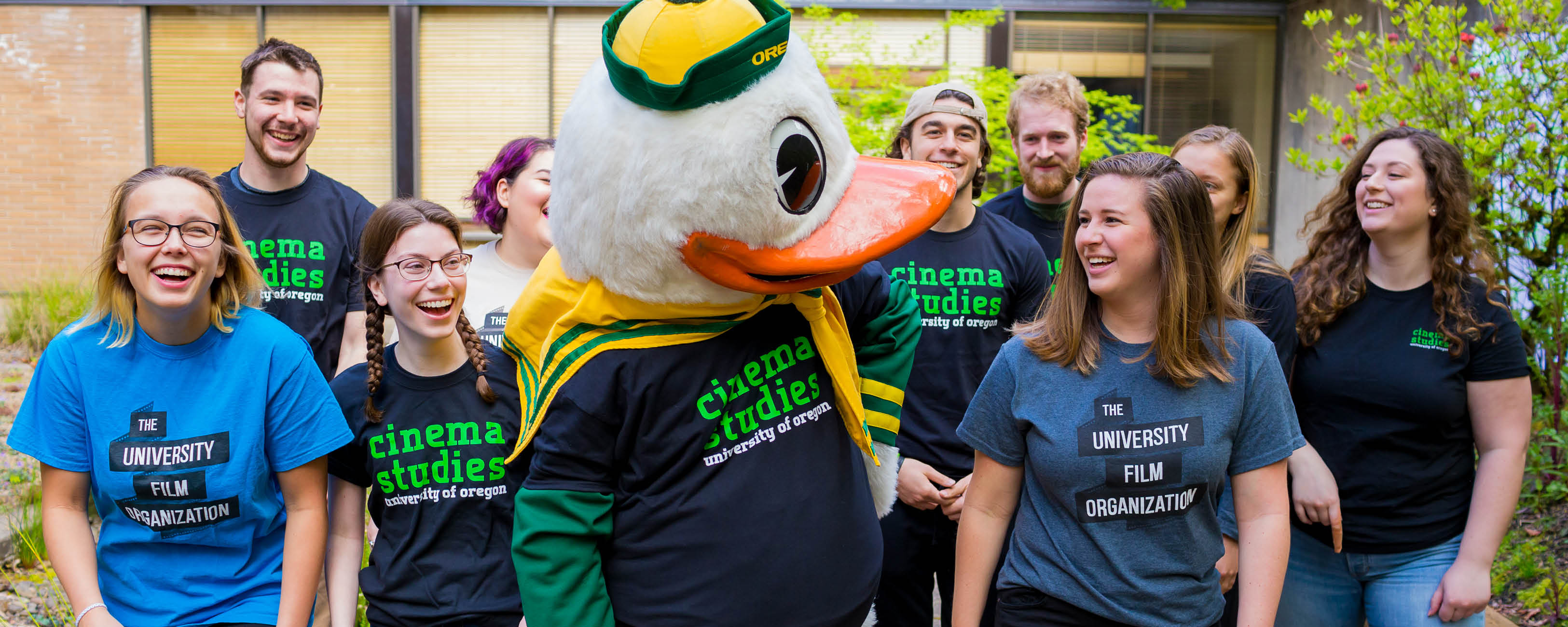 Students walking outside with the Duck mascot