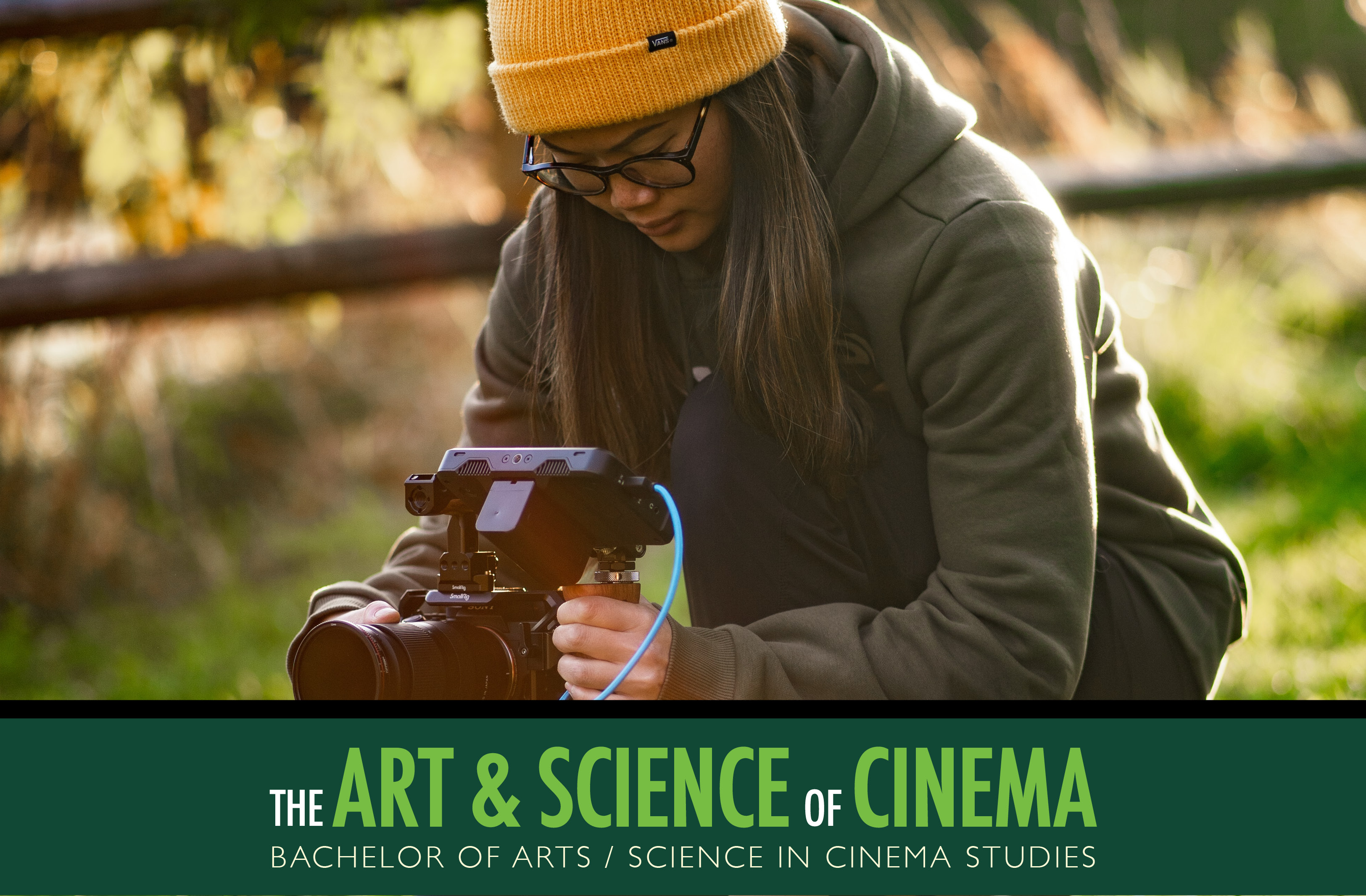 Person kneeling on the ground outside with a camera. Text at the bottom of the photo: The Art and Science of Cinema. BACHELOR OF ARTS / SCIENCE IN CINEMA STUDIES