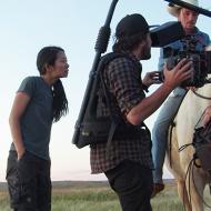 Photo of Chloé Zhao directing a scene on the set of "The Rider"